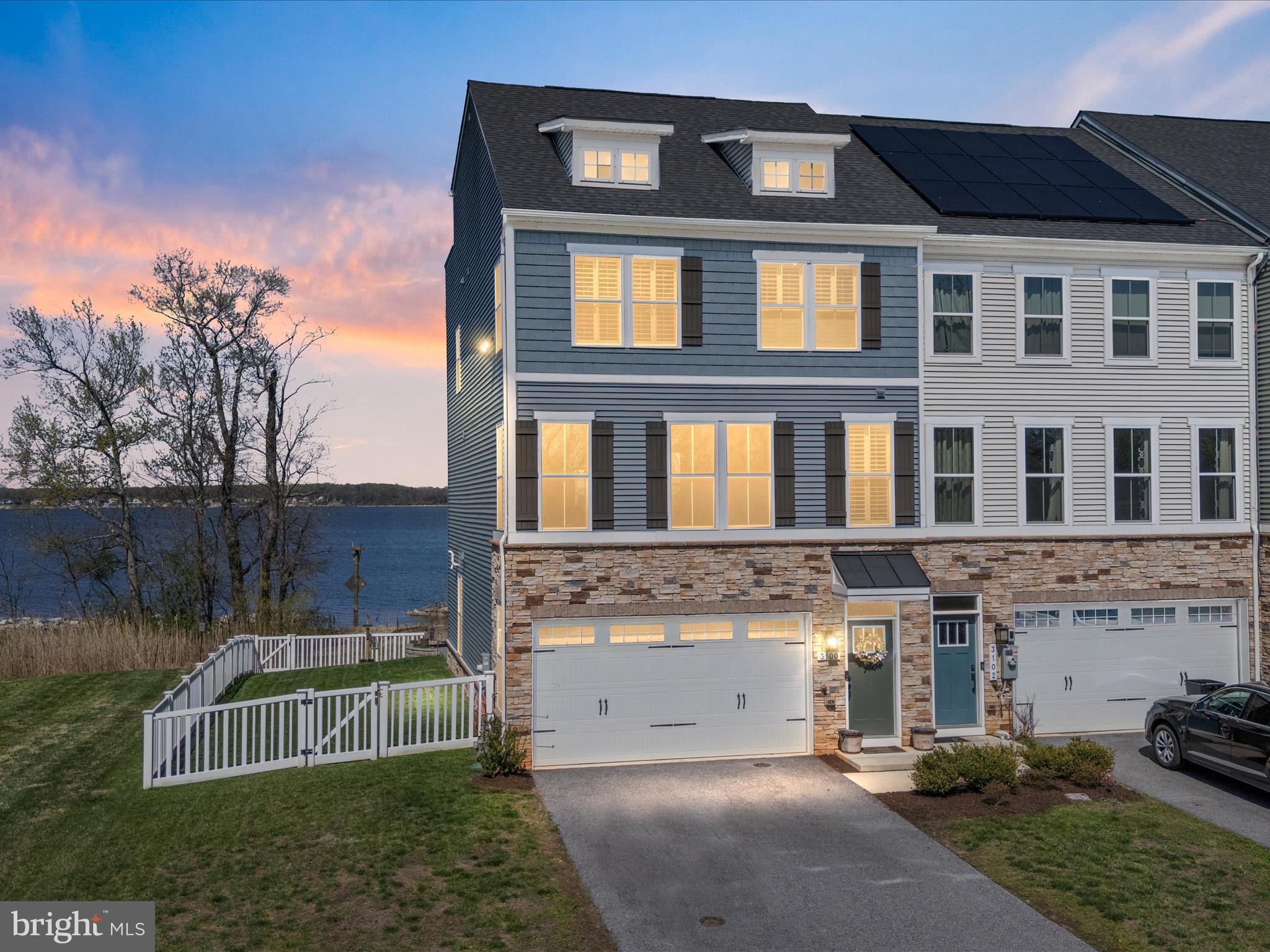 3100 Shaws Road Edgemere, MD 21219 - Photo 1 of 88 a view of a brick house with many windows next to a yard