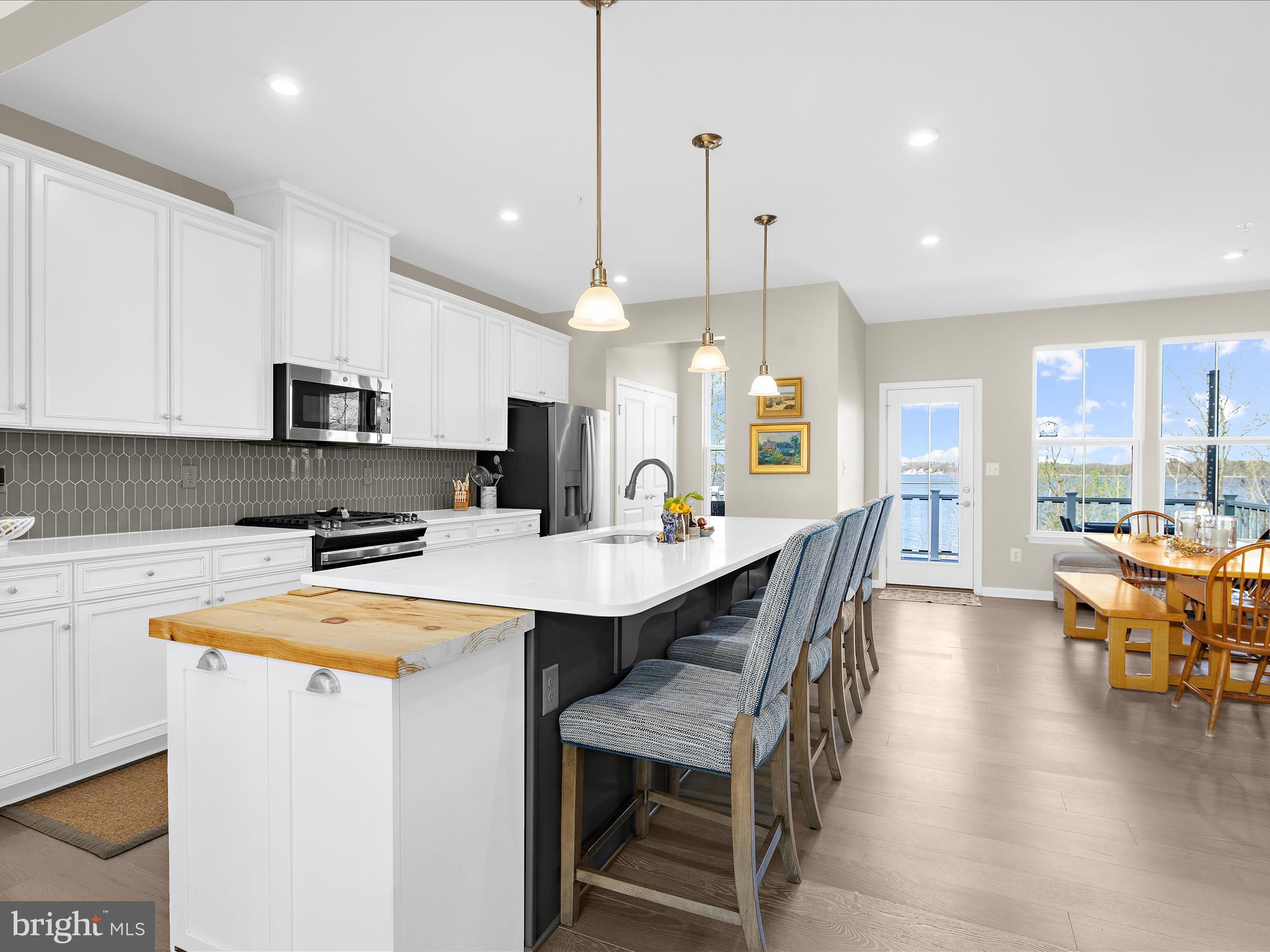 3100 Shaws Road Edgemere, MD 21219 - Photo 18 of 88 a kitchen with stainless steel appliances a table chairs refrigerator and microwave