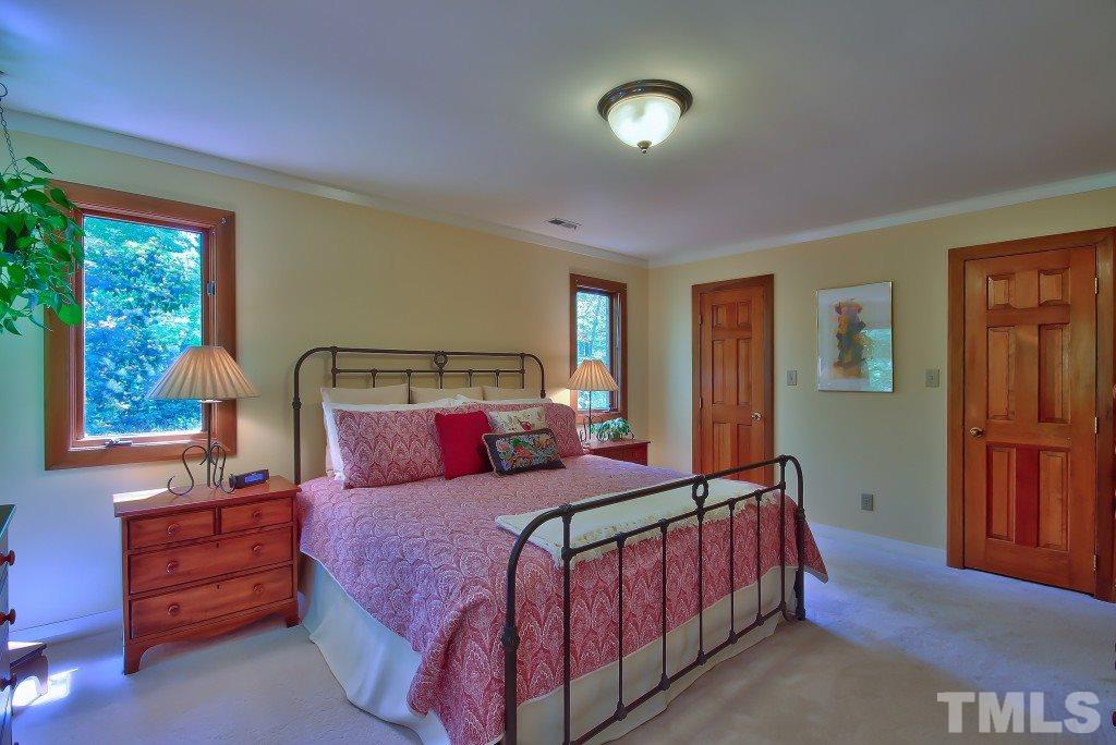 10008 Old Warden Road Raleigh, NC 27615 - Photo 11 of 24 a bedroom with a bed and window