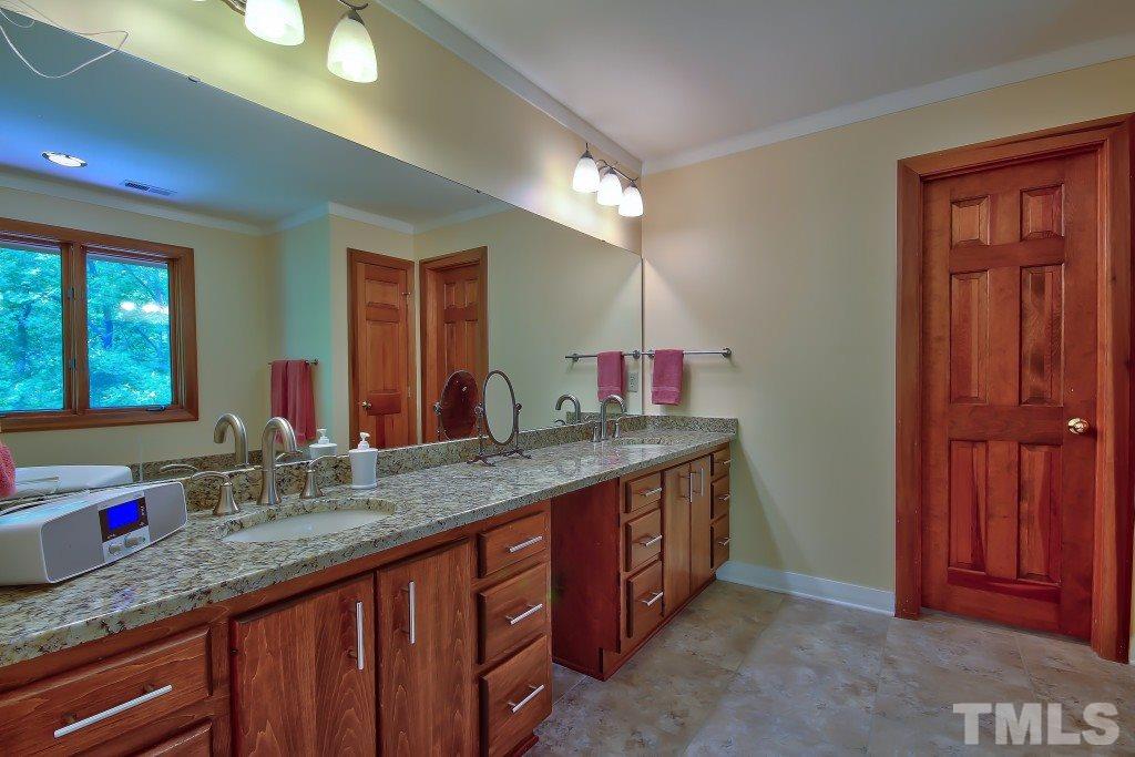 10008 Old Warden Road Raleigh, NC 27615 - Photo 12 of 24 a bathroom with a granite countertop double vanity sink and a mirror