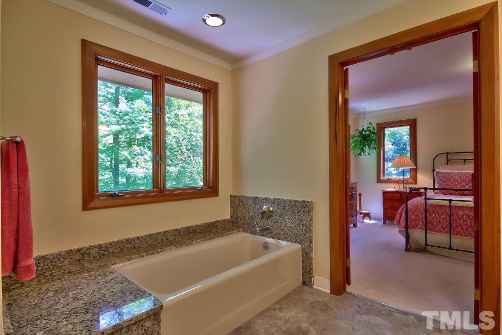 10008 Old Warden Road Raleigh, NC 27615 - Photo 13 of 24 a bath tub sitting in a bathroom next to a window