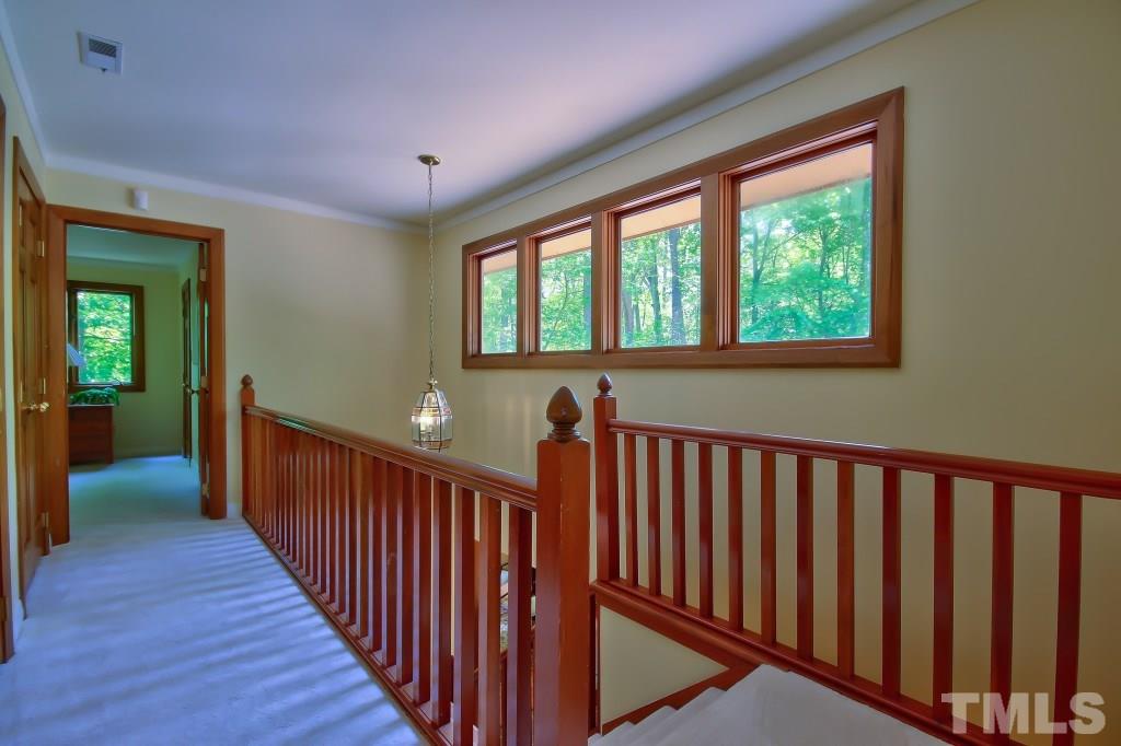 10008 Old Warden Road Raleigh, NC 27615 - Photo 14 of 24 a view of a hallway with wooden floor and stairs