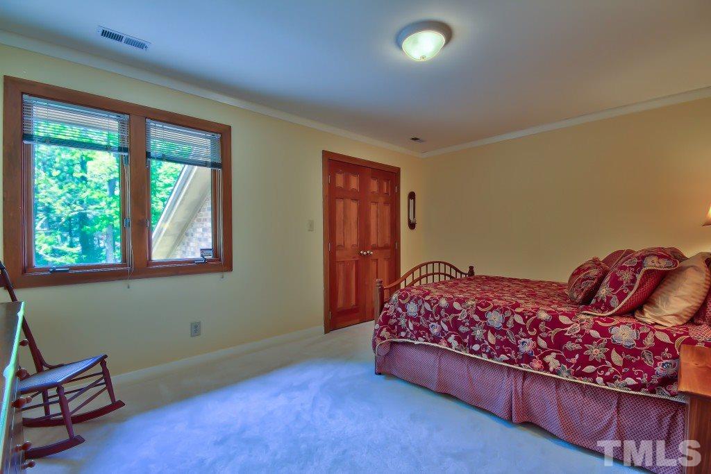 10008 Old Warden Road Raleigh, NC 27615 - Photo 15 of 24 a bed room with a bed and a window