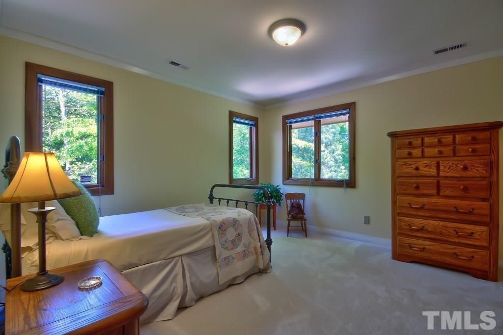 10008 Old Warden Road Raleigh, NC 27615 - Photo 16 of 24 a bedroom with a bed and a window