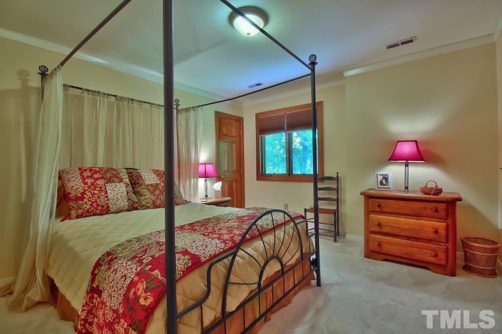 10008 Old Warden Road Raleigh, NC 27615 - Photo 17 of 24 a bedroom with bed and a window