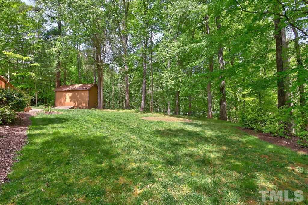 10008 Old Warden Road Raleigh, NC 27615 - Photo 20 of 24 a view of a big yard with large trees