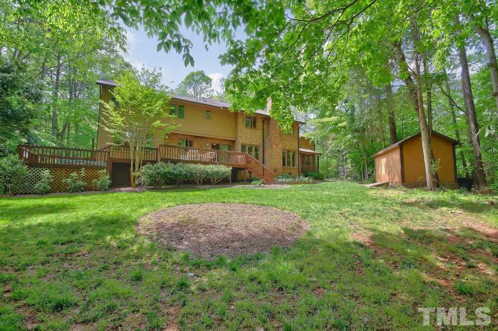 10008 Old Warden Road Raleigh, NC 27615 - Photo 22 of 24 a view of a backyard with large trees and plants