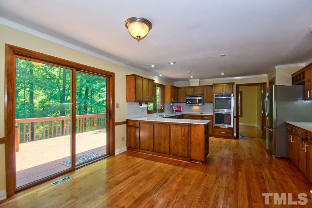 10008 Old Warden Road Raleigh, NC 27615 - Photo 4 of 24 a view of kitchen with cabinets and wooden floor