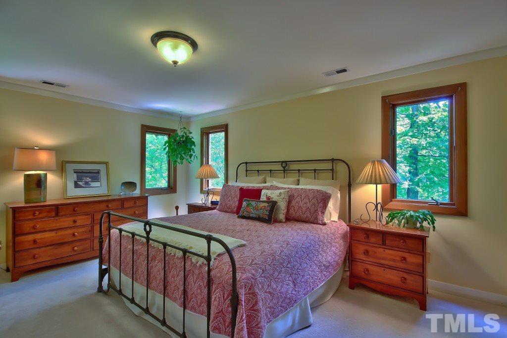 10008 Old Warden Road Raleigh, NC 27615 - Photo 10 of 24 a bedroom with a bed and a dresser