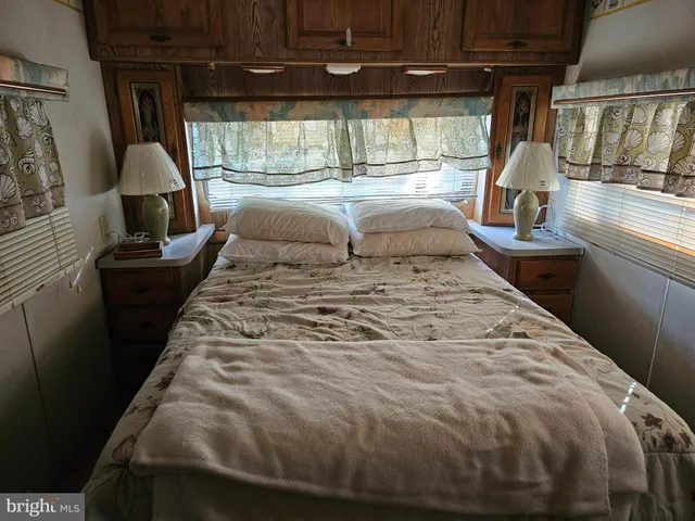 a bed sitting in a bedroom next to a window