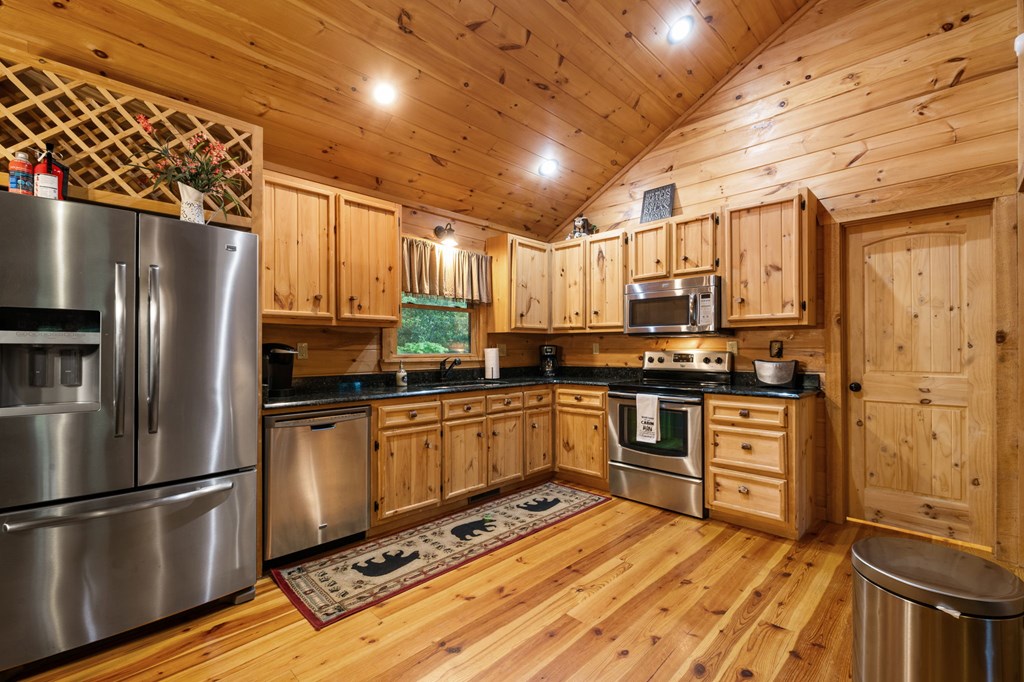 205 Mountain View Road Cherry Log, GA 30522 - Photo 11 of 28 a kitchen with stainless steel appliances granite countertop a refrigerator a sink dishwasher a stove and white countertops with wooden floor