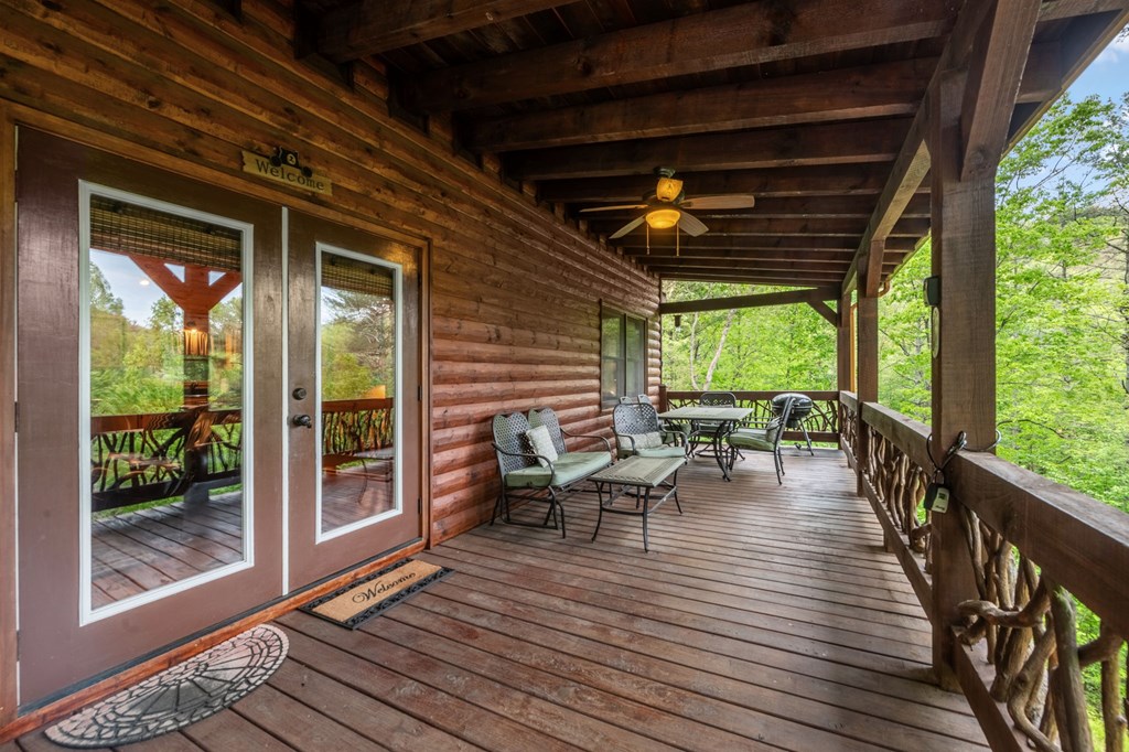 205 Mountain View Road Cherry Log, GA 30522 - Photo 5 of 28 a view of a deck with wooden floor and outdoor seating
