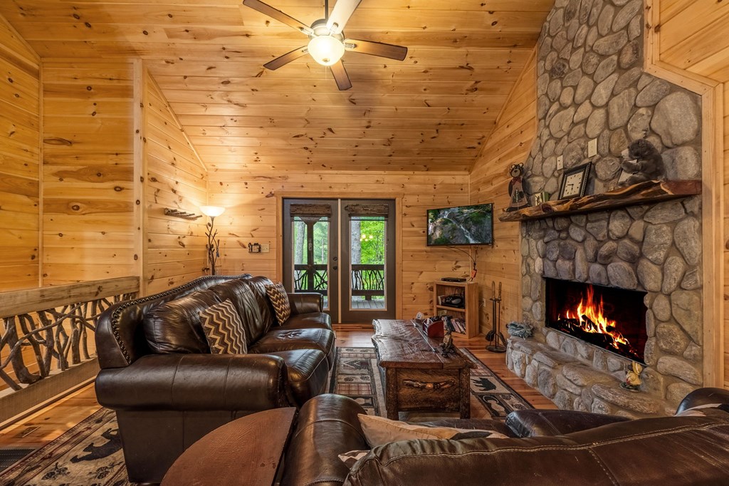 205 Mountain View Road Cherry Log, GA 30522 - Photo 8 of 28 a living room with furniture a fireplace and a flat screen tv