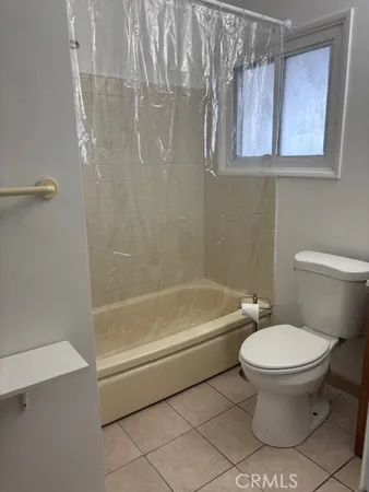 a bathroom with a toilet and a bathtub