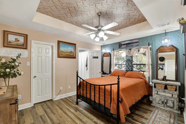 a bedroom with bed and wooden floor
