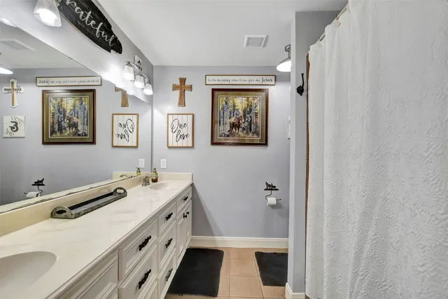 a bathroom with a sink a toilet a shower and a mirror