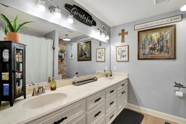 a bathroom with a double vanity sink and a mirror