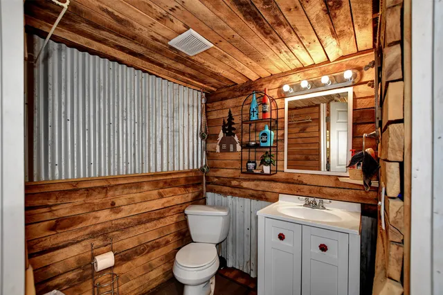 a view of house with a yard and potted plants