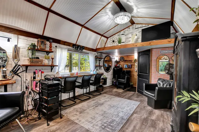 a room with wooden furniture and large windows