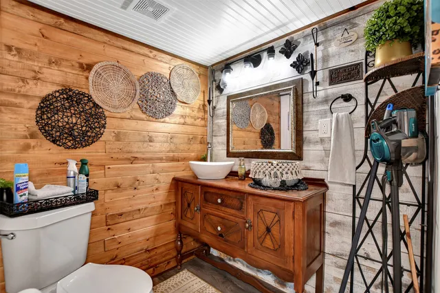 a view of a wooden house with a large tree