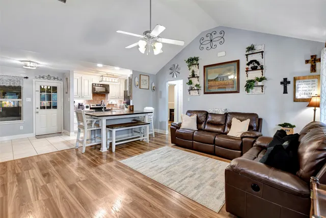 a living room with furniture and a wooden floor