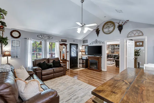 a living room with furniture a fireplace and a flat screen tv
