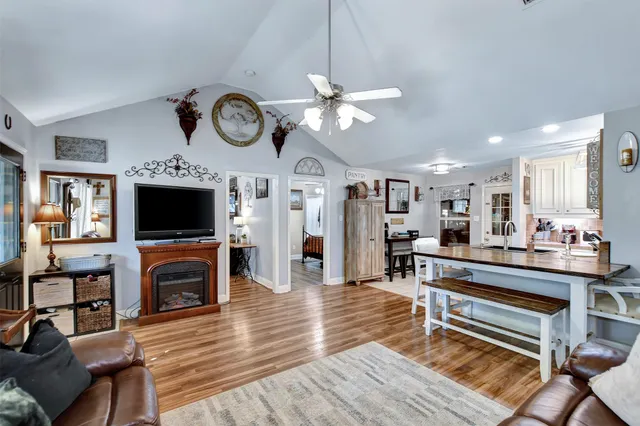 a living room with fireplace furniture and a flat screen tv
