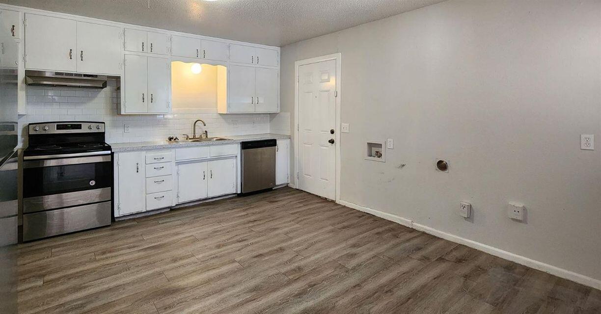 4401 31st Street Lubbock, TX 79410 - Photo 12 of 21 a kitchen with a sink and a stove top oven
