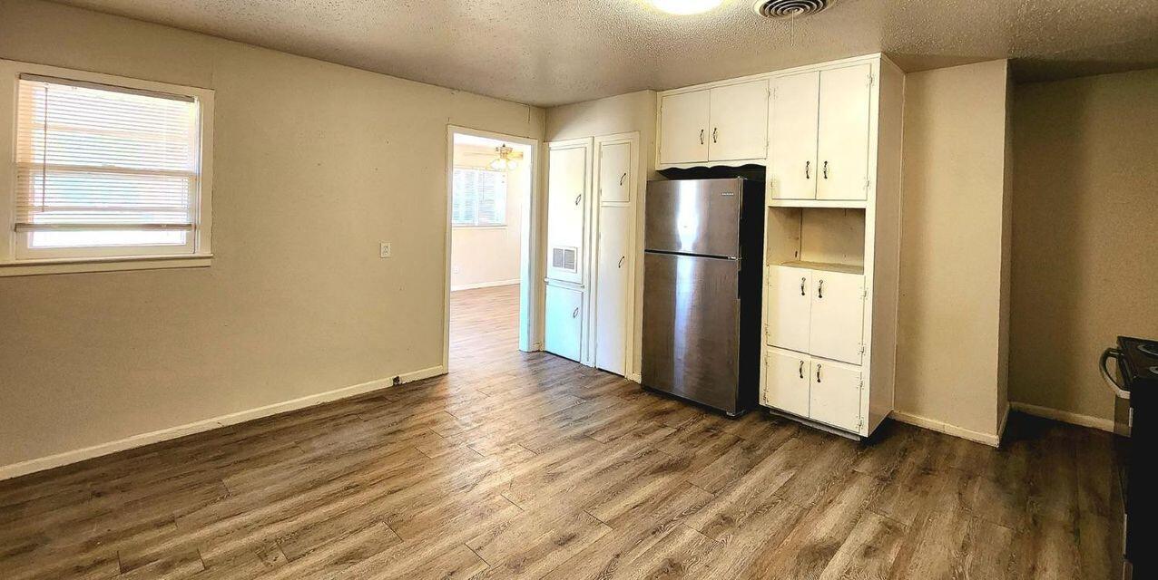 4401 31st Street Lubbock, TX 79410 - Photo 13 of 21 a view of a kitchen with wooden floor electronic appliances and windows