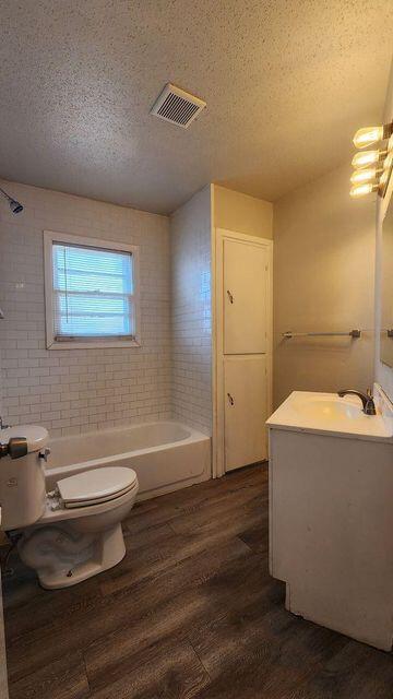 4401 31st Street Lubbock, TX 79410 - Photo 17 of 21 a bathroom with a toilet a sink and bathtub