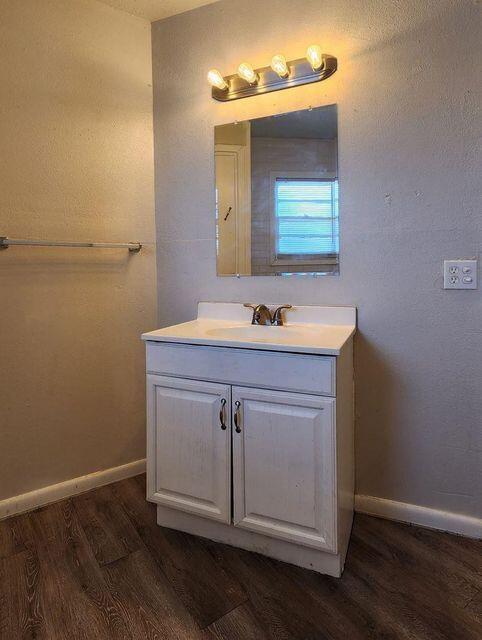 4401 31st Street Lubbock, TX 79410 - Photo 18 of 21 a bathroom with a sink and a mirror