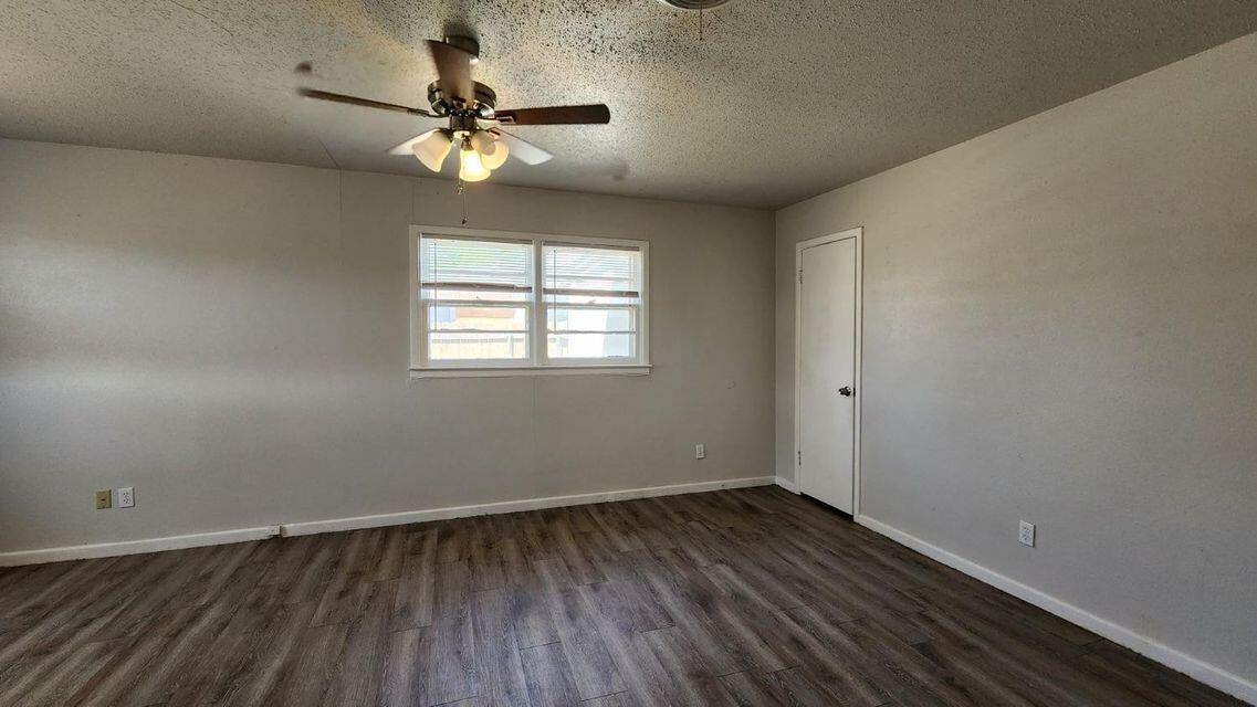 4401 31st Street Lubbock, TX 79410 - Photo 19 of 21 a view of wooden floor and a chandelier fan in a room