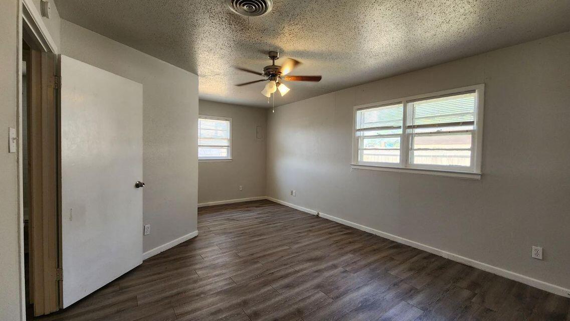4401 31st Street Lubbock, TX 79410 - Photo 20 of 21 wooden floor in an empty room with a window