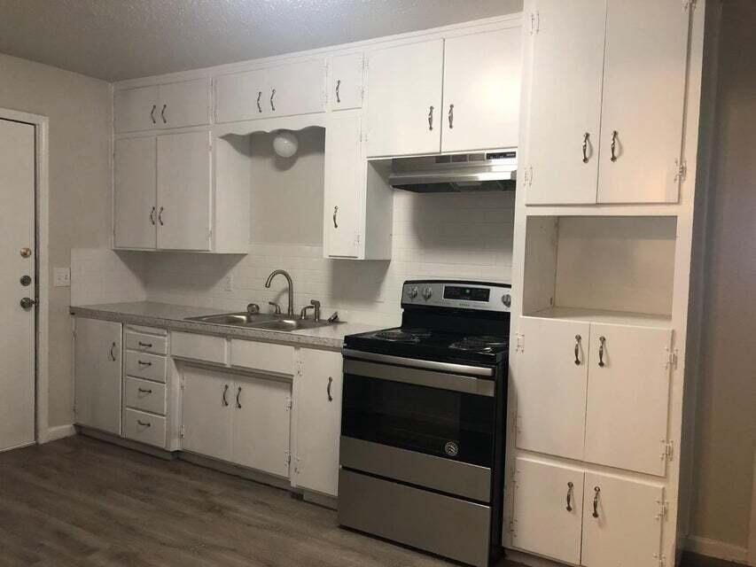 4401 31st Street Lubbock, TX 79410 - Photo 5 of 21 a kitchen with cabinets stainless steel appliances and a sink