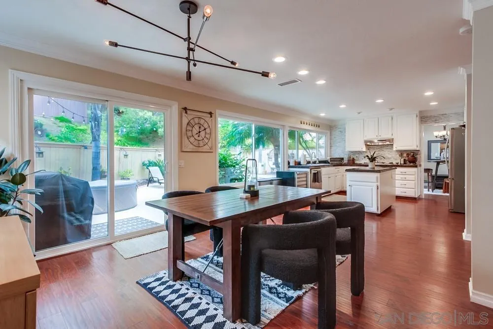 1846 Olympus Loop Drive Vista, CA 92081 - Photo 12 of 34 a kitchen with stainless steel appliances granite countertop a stove a refrigerator a kitchen island a table and chairs