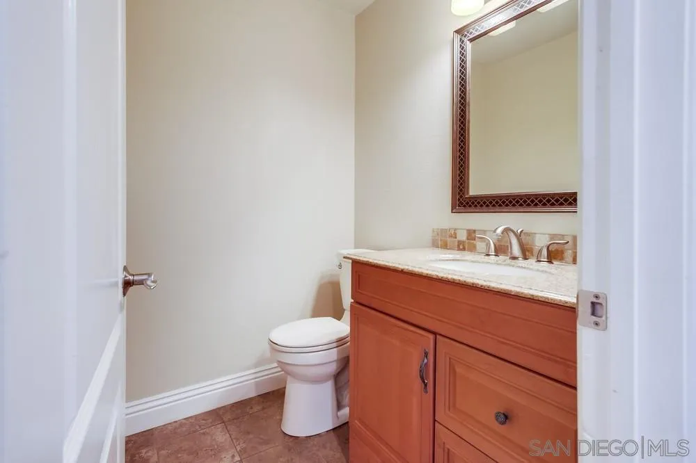 1846 Olympus Loop Drive Vista, CA 92081 - Photo 17 of 34 a bathroom with a sink and a mirror