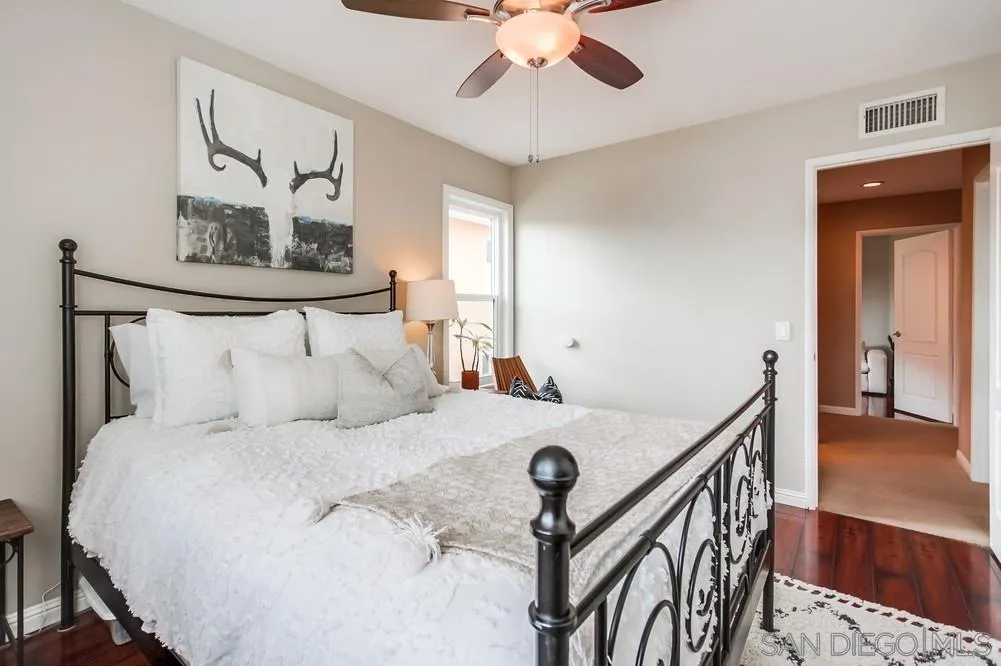 1846 Olympus Loop Drive Vista, CA 92081 - Photo 29 of 34 a bedroom with a bed and a chandelier