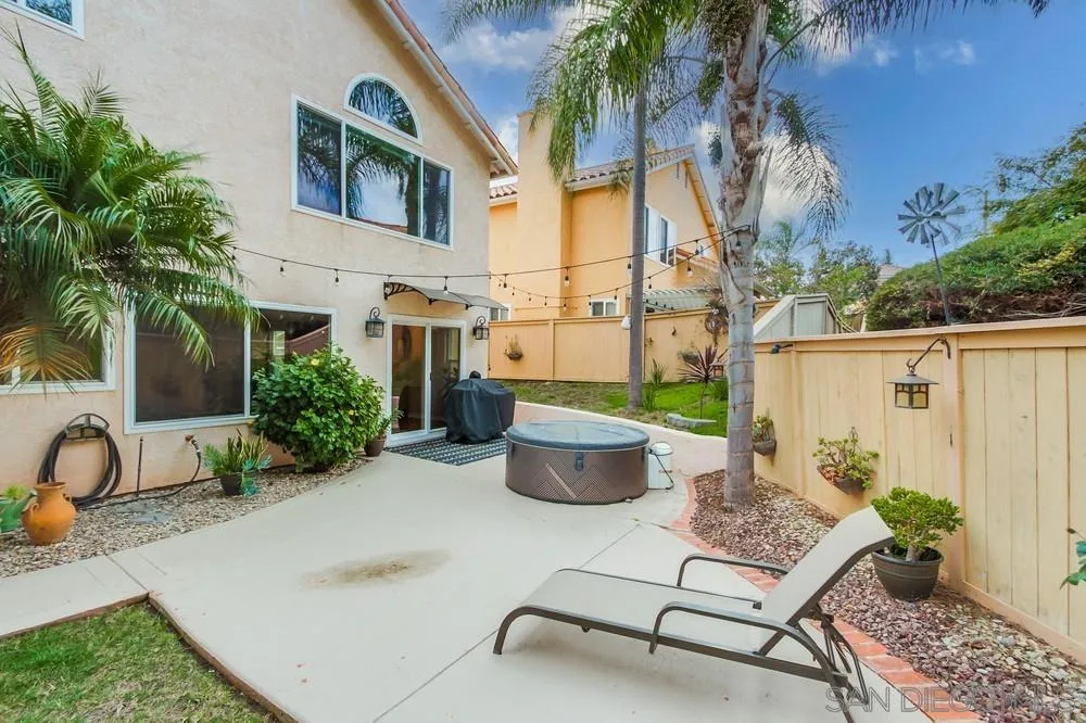 1846 Olympus Loop Drive Vista, CA 92081 - Photo 31 of 34 a backyard of a house with table and chairs potted plants