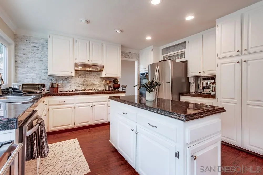 1846 Olympus Loop Drive Vista, CA 92081 - Photo 10 of 34 a kitchen with stainless steel appliances granite countertop a refrigerator a stove and a sink