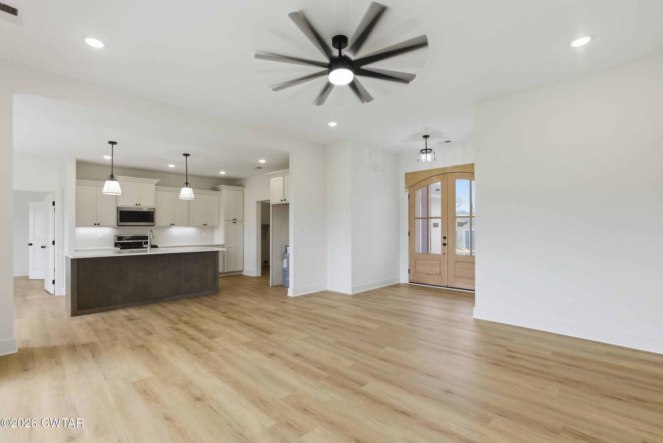 179 Daybreak Loop Medina, TN 38355 - Photo 10 of 32 a large room with a kitchen island in the center
