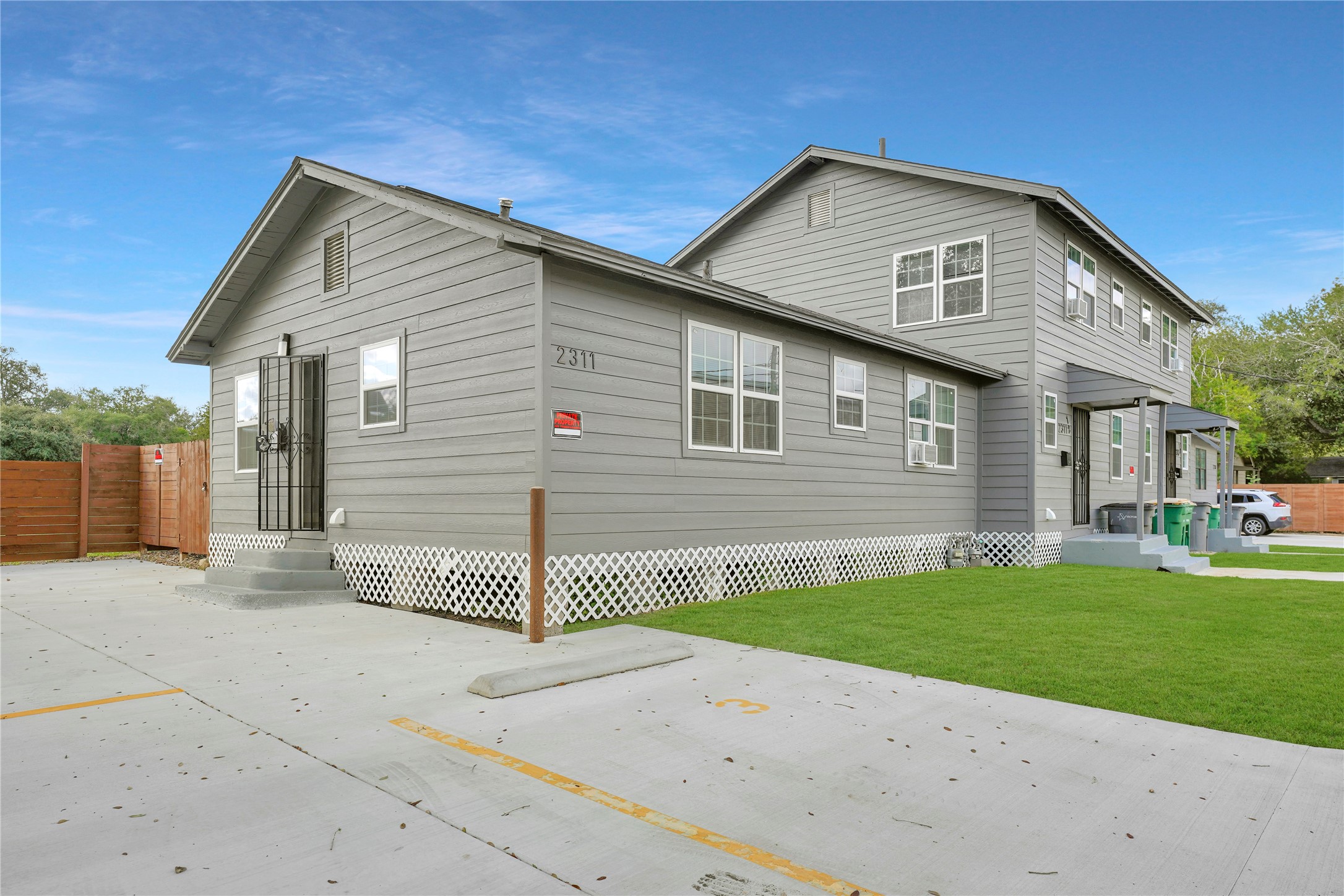 2311 North Louis Street Victoria, TX 77901 - Photo 2 of 21 a front view of a house with a yard and garage