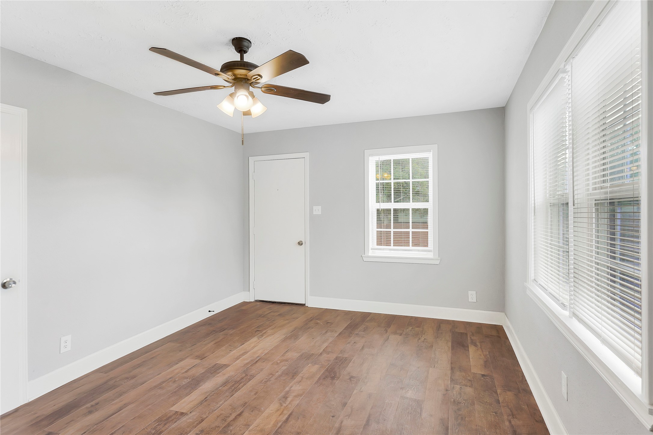 2311 North Louis Street Victoria, TX 77901 - Photo 4 of 21 wooden floor in an empty room with a window