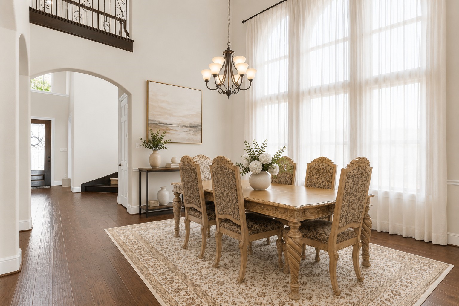 4022 Sabine Valley Trail Spring, TX 77386 - Photo 8 of 46 Elegant dining room with high ceilings, large windows and a classic chandelier. The space is bright and airy, with hardwood floors leading to an open entryway. Virtually staged to show the room’s potential.