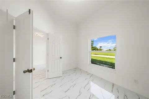 a view of an empty room and a window