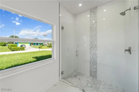 a bathroom with a shower and a sink