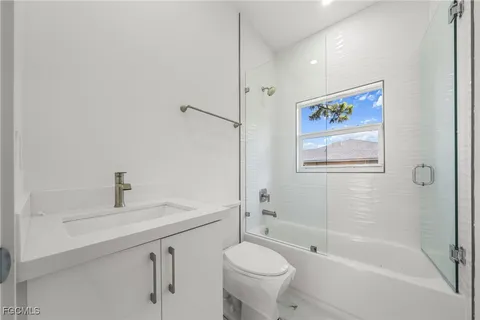 a bathroom with a sink mirror toilet and bathtub