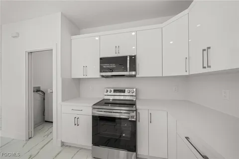 a kitchen with stainless steel appliances a stove a microwave and cabinets