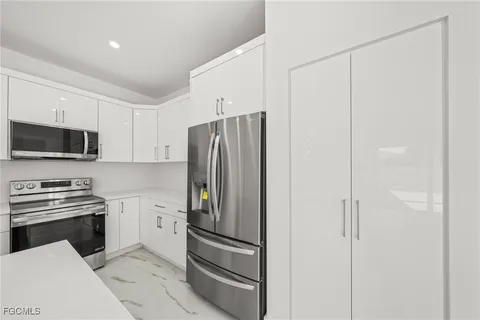 a kitchen with stainless steel appliances and refrigerator