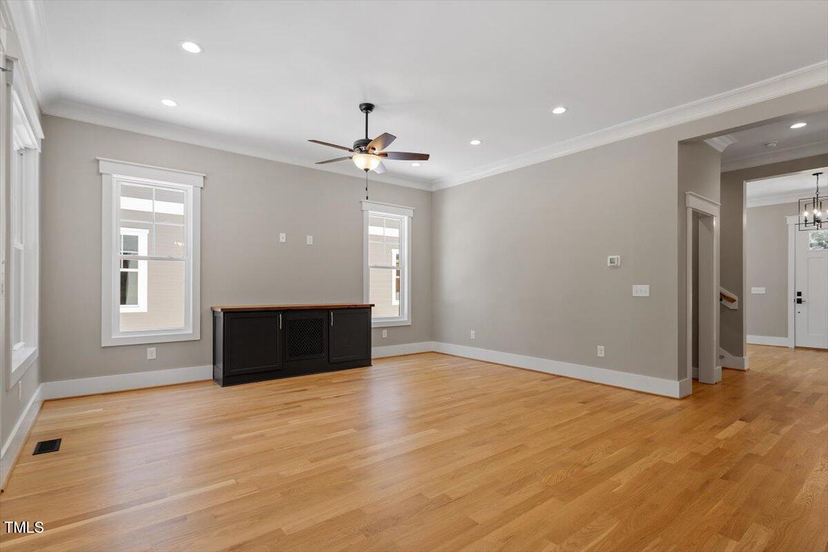 3934 Old Chapel Hill Road Durham, NC 27707 - Photo 23 of 47 an empty room with wooden floor chandelier and windows