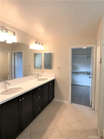 a bathroom with a sink vanity and mirror